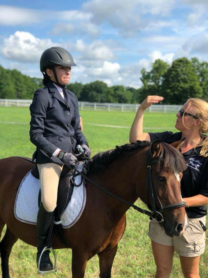 Lilly Becker coaches a student before competing at Old Chatham Mix and Match.